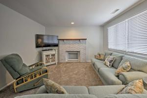 a living room with a couch and a fireplace at Central Sea Isle City Condo - 1 Block to the Beach in Sea Isle City