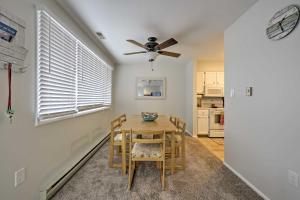 a dining room with a table and chairs and a ceiling fan at Central Sea Isle City Condo - 1 Block to the Beach in Sea Isle City