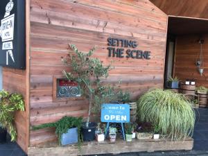 a building with a sign that reads sitting the scene at HOTEL The Scene in Yokohama