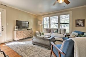 a living room with a couch and a tv at Fredericksburg Cottage with Grill - Walk to Main St! in Fredericksburg