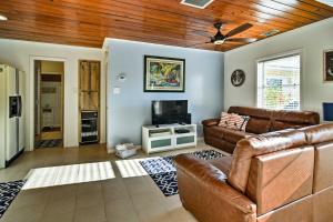 a living room with a couch and a television at Indian Shores Cottage with Cabana - Steps to Beach! in Clearwater Beach