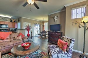 a living room with a couch and a tv at Ground-Floor Poolside Mesa Condo with Luxe Amenities in Mesa