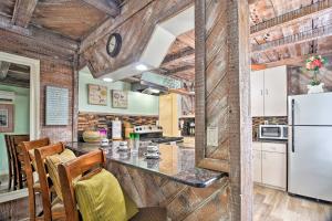 a kitchen with a counter and a refrigerator at Driftwood Beach Cottage - Walk to Clearwater Bch in Clearwater Beach