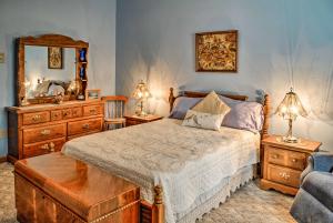 a bedroom with a bed with a dresser and a mirror at Waterfront Wellesley Island Apt with Private Dock! in Point Vivian