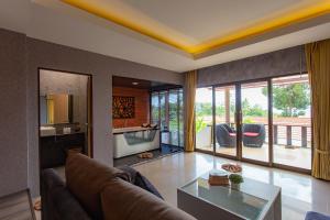 a living room with a couch and a table at Sita Beach Resort in Ko Lipe