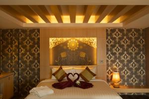 a bedroom with a bed with a bow on it at Sita Beach Resort in Ko Lipe