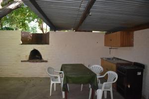 a patio with a table and chairs and a stove at Dos ruedas in Mina Clavero +27 photos