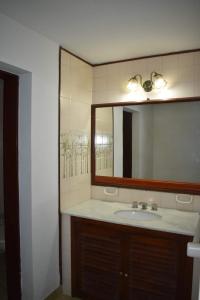 a bathroom with a sink and a mirror at Dos ruedas in Mina Clavero