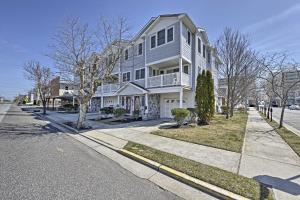 a large white house on the side of a street at Wildwood Townhome with Patio 1 Block To The Beach! in Wildwood