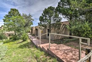 a walkway leading up to a house with trees at Adobe-Style Abode with Amenities - Walk to Plaza! in Santa Fe