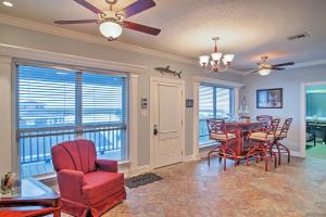 a living room with a dining room table and chairs at Waterfront Slidell Home with Boat Dock and Canal View! in Slidell