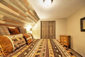 a bedroom with a bed and a wooden ceiling at Hillside Cripple Creek Cabin with Hot Tub, Mtn Views in Cripple Creek