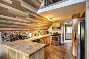 a kitchen with wooden floors and a wooden ceiling at Hillside Cripple Creek Cabin with Hot Tub, Mtn Views! in Cripple Creek