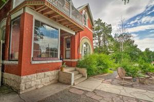 a red brick house with a window and a chair at Central Colorado Springs Home with Alluring Backyard in Colorado Springs