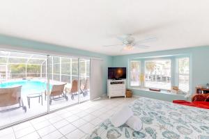 a bedroom with a bed and a swimming pool at Coconut Tree in Anna Maria