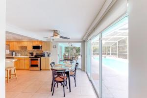 a kitchen and dining room with a table and chairs at Coconut Tree in Anna Maria