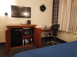 
a bedroom with a television and a desk at The Lexington at Jackson Hole in Jackson
