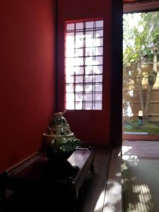 a vase sitting on a table in a room with a window at むつわ柒 in Kanazawa