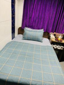 a bedroom with a bed with purple curtains at Premium Lounge in Hong Kong