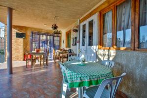 a room with a table and chairs on a patio at Gantiadi in Kutaisi