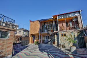 a cobblestone street in a town with buildings at Gantiadi in Kutaisi