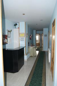 a kitchen with a refrigerator and a table in a room at Gran Vía in Lugo