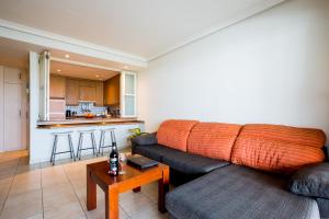 a living room with a couch and a table at Apartamentos Balcon de Los Gigantes in Puerto de Santiago