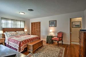 a bedroom with a bed and a desk and a chair at Historic Lakefront Gem about 6 Mi to Bok Tower Gardens in Lake Wales