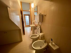 a bathroom with two toilets and a sink at Villa Moroni in Sondrio +19 photos