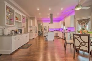 a large kitchen with white cabinets and a purple ceiling at Duluth Home with Patio 22 Mi to Downtown Atlanta! in Duluth