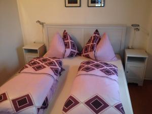 a bedroom with two beds with pillows on it at Haus Tischler Ferienwohnungen in Ramingstein