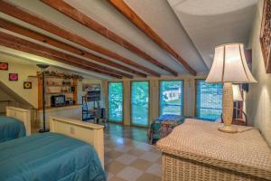 a bedroom with a bed and a table with a lamp at Russellville House with Garden - Walk to Main Street in Russellville