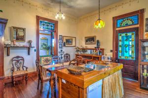 a kitchen with a sink and a table with chairs at Russellville House with Garden - Walk to Main Street in Russellville