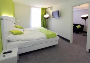 Postel nebo postele na pokoji v ubytování Hotel City Inn Basel
