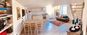 a kitchen and living room with a table and chairs at Heart of Rome Vatican Deluxe New Apartment 1GB WiFi in Rome