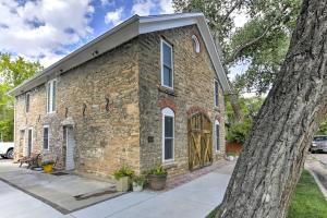 an old brick building with a large tree at Charming Historic Condo - Walk to Downtown and UW in Laramie