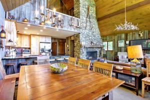 a kitchen and dining room with a wooden table at East Burke House with Deck Less Than 3 Mi to Kingdom Trails! in East Burke