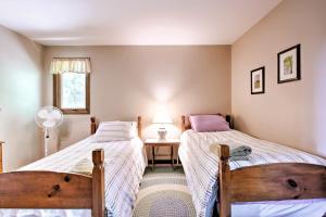 a bedroom with two beds and a table with a lamp at East Burke House with Deck Less Than 3 Mi to Kingdom Trails! in East Burke