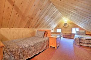a attic bedroom with a bed and a table in it at Cozy Bakers Mills Cottage Less Than 8 Mi to Gore Mountain! in Bakers Mills