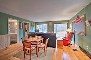 a living room with a table and a couch at Cozy Bakers Mills Cottage Less Than 8 Mi to Gore Mountain! in Bakers Mills