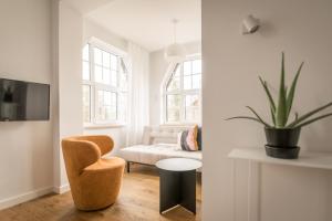 a living room with a chair and a couch at Kolorowe Pola Boutique B&B in Polanica-Zdrój