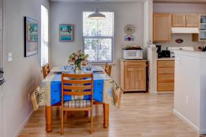 a kitchen with a table with a vase of flowers on it at Serene Bungalow-Style Home in Point Reyes Station! in Point Reyes Station