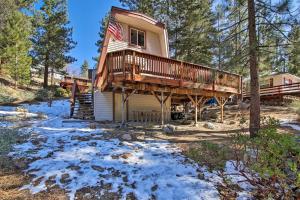 a house with a wrap around deck in the woods at Cabin with Deck and Hot Tub Walk to Big Bear Lake! in Fawnskin