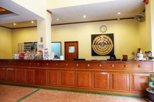 a waiting area of a hospital with a large wooden counter at Patong Central Residence and Apartment in Patong Beach