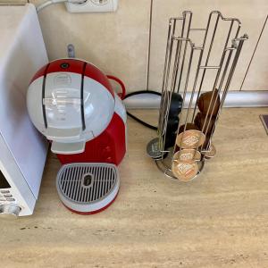 a red blender sitting on the floor next to a box at Alisia House in Sibiu