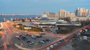 a large parking lot with cars in a city at Staybridge Mini-Hotel in Most City PANORAMIC RIVER VIEW in Dnipro +13 photos