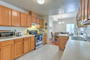 a large kitchen with wooden cabinets and a kitchen island at Home 5 Mi to Colonial Pkwy, 11 Mi to Busch Gardens in Williamsburg