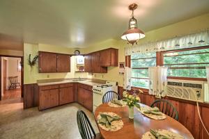 a kitchen with wooden cabinets and a table with chairs at Cherry Cottage - Walk to Peninsula State Park! in Ephraim