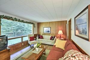 a living room with a couch and a tv at Cherry Cottage - Walk to Peninsula State Park! in Ephraim