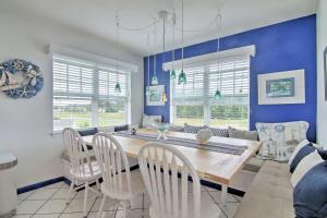 a dining room with blue walls and a table and chairs at Ocean View Condo by Bethany Beach with Balcony! in Ocean View